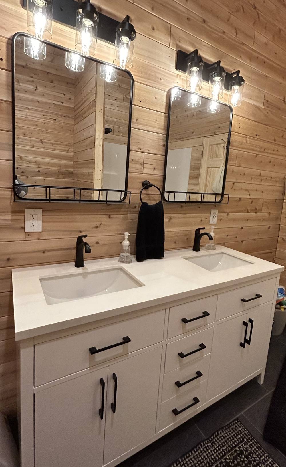 Finished double-sink bathroom vanity with cedar paneled walls