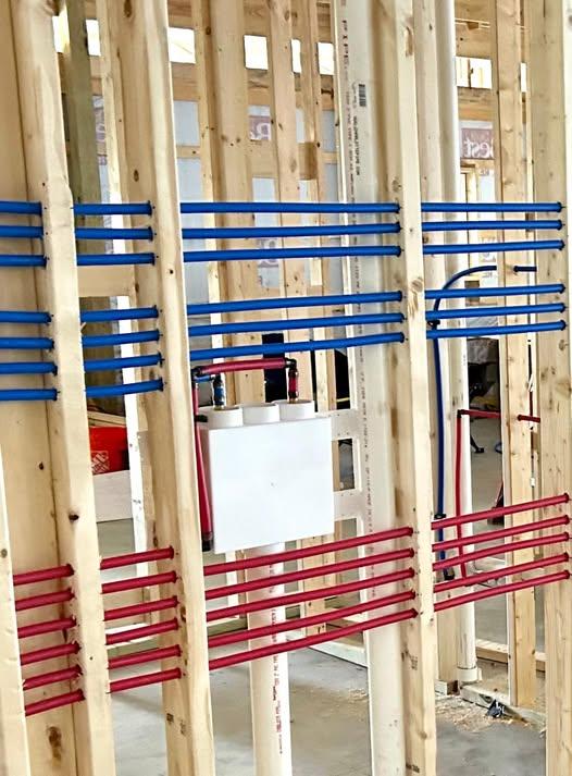 Color-coded PEX plumbing rough-in during new home construction
